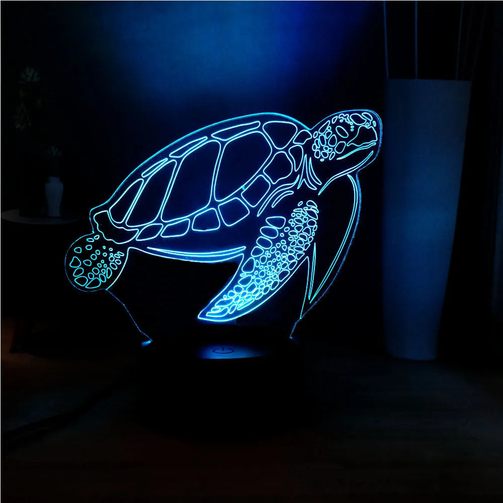 Clear acrylic 3D turtle-shaped LED night light showing multiple colour options on a dark surface.