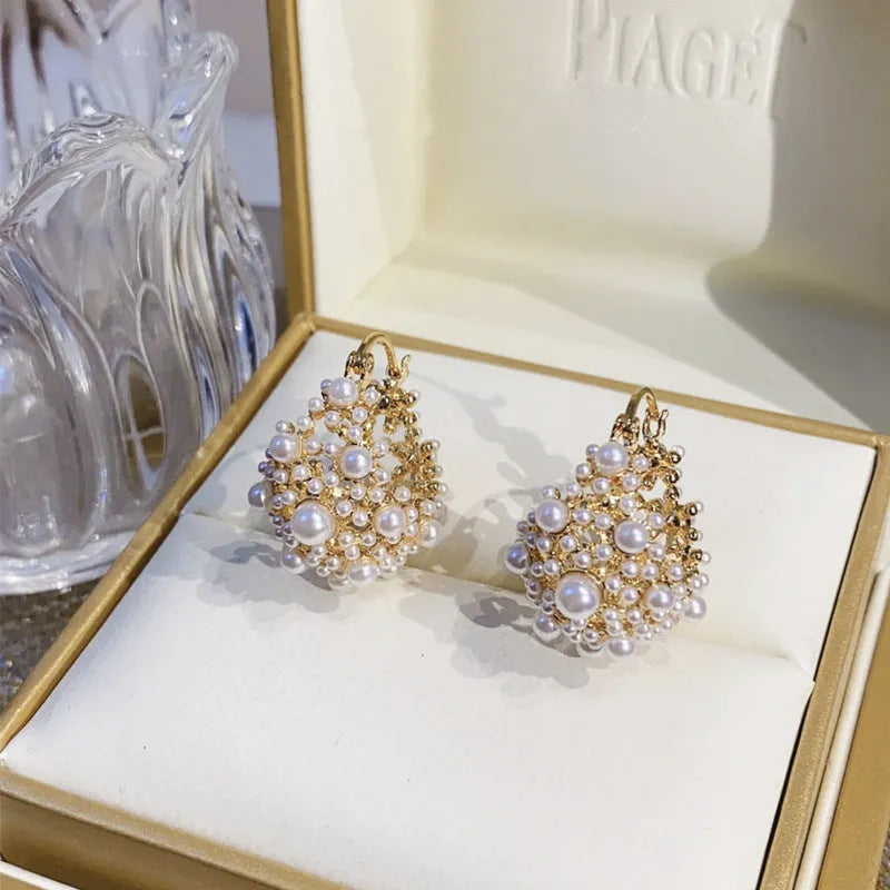 Gold-coloured copper earrings with a small bead flower basket design.