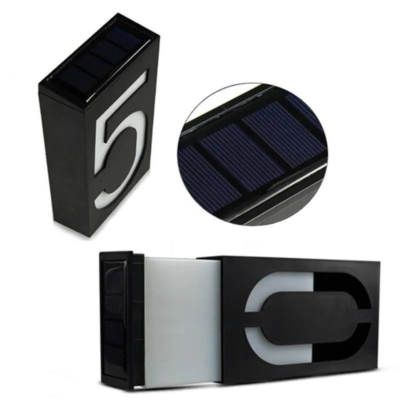 Solar-powered white LED house number light mounted on an outdoor wall