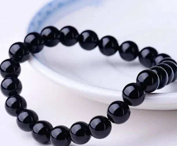 Geometric black agate stretch bracelet with 8mm beads on an elastic cord.