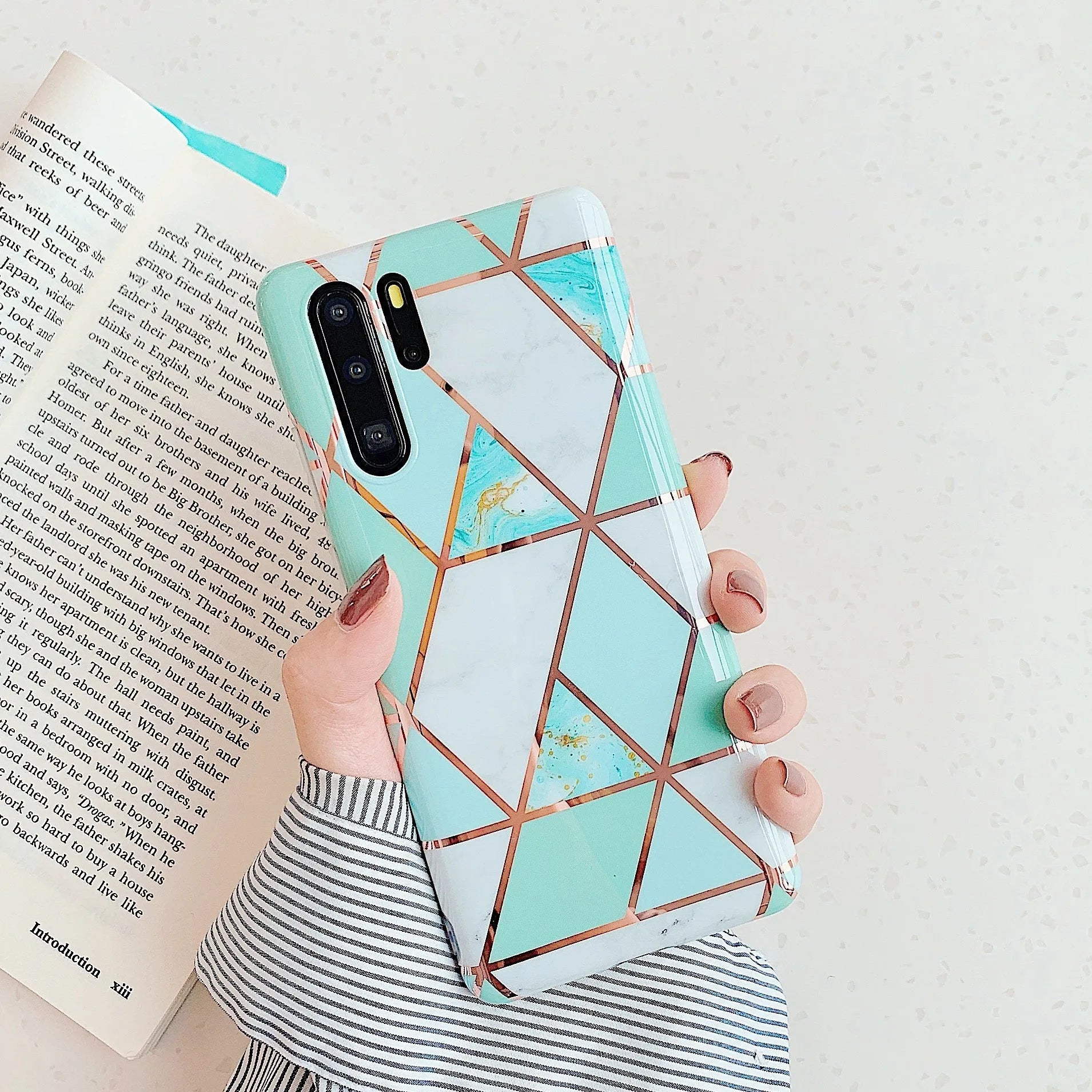 Glossy electroplated marble design TPU back cover case for a Huawei smartphone.