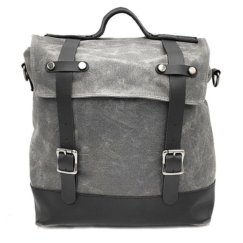Black waterproof canvas motorcycle side pannier bag with cowhide accents showing mounting straps