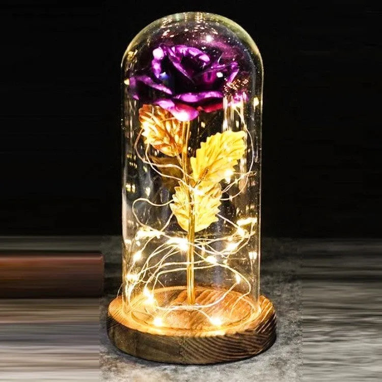 LED rose ornament with silk flowers under glass shade, showing colour options on a wooden base.