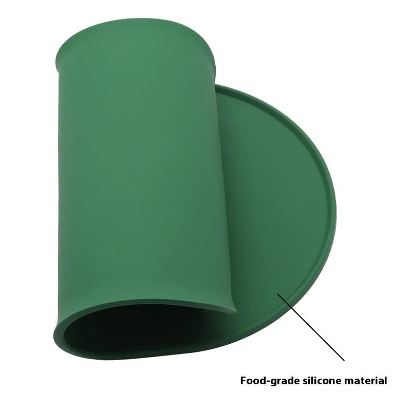 Green silicone waterproof pet feeding placemat with a food bowl on it.