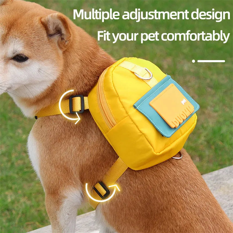 Blue adjustable dog harness backpack with storage compartment and tow rope shown on a medium-sized dog.