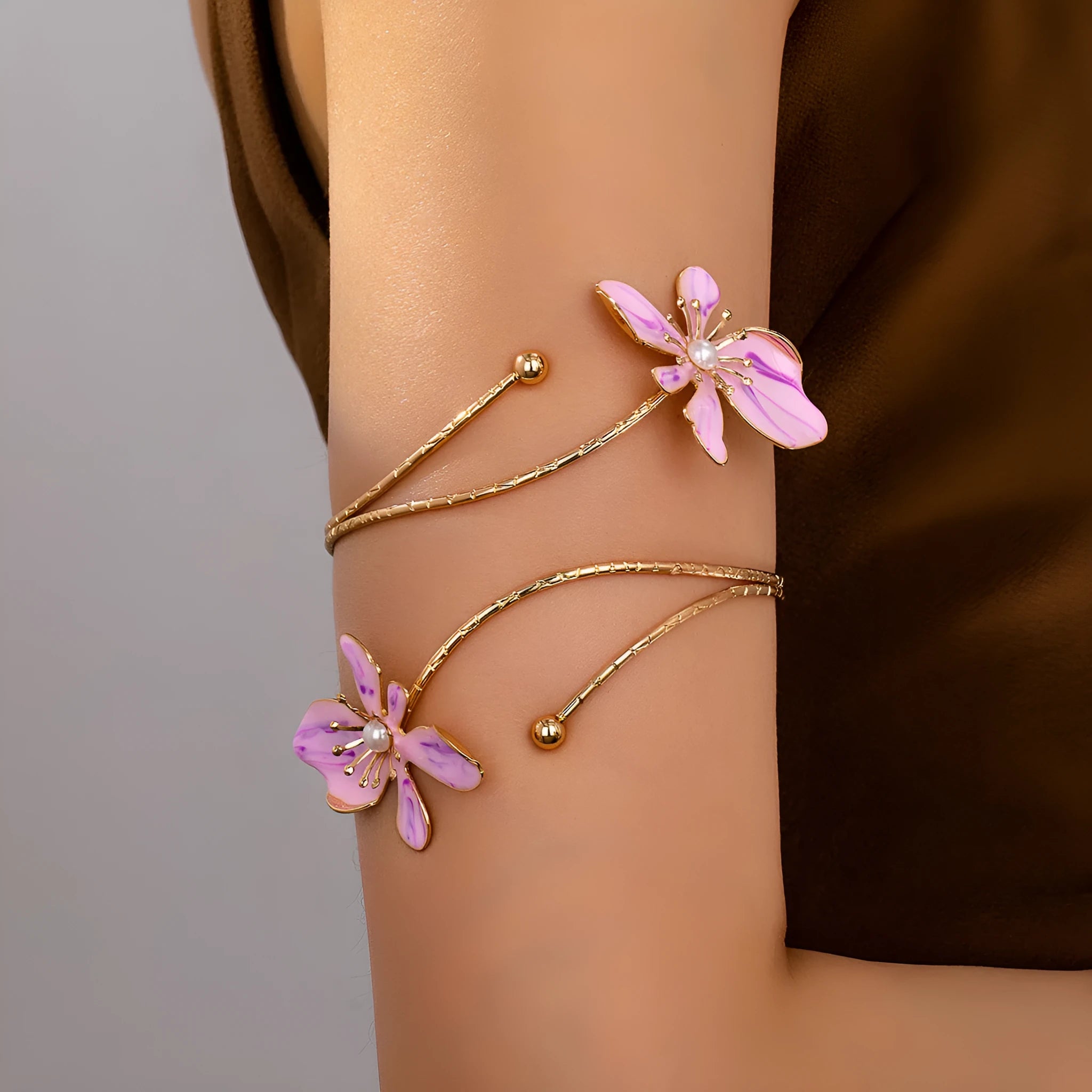 Pink alloy armband with hollow pattern design showing adjustable sizing and cut-out details