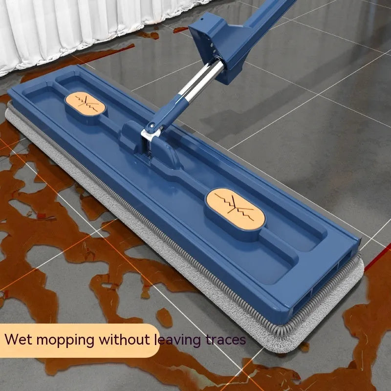 Large flat mop with long stainless steel handle and blue cleaning cloth on a hard floor.