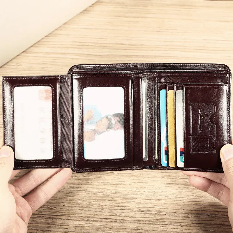 Men's black leather wallet open to show internal compartments: photo slot, card slots, banknote folder, and change pocket.