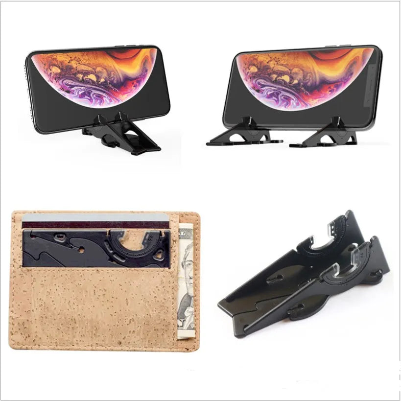 Black plastic card-type mobile phone holder propping a smartphone on a desktop