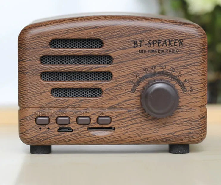 Vintage wood Bluetooth speaker in pink, black, and wood grain colours showing compact 93x70x59mm dimensions