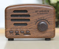 Vintage wood Bluetooth speaker in pink, black, and wood grain colours showing compact 93x70x59mm dimensions