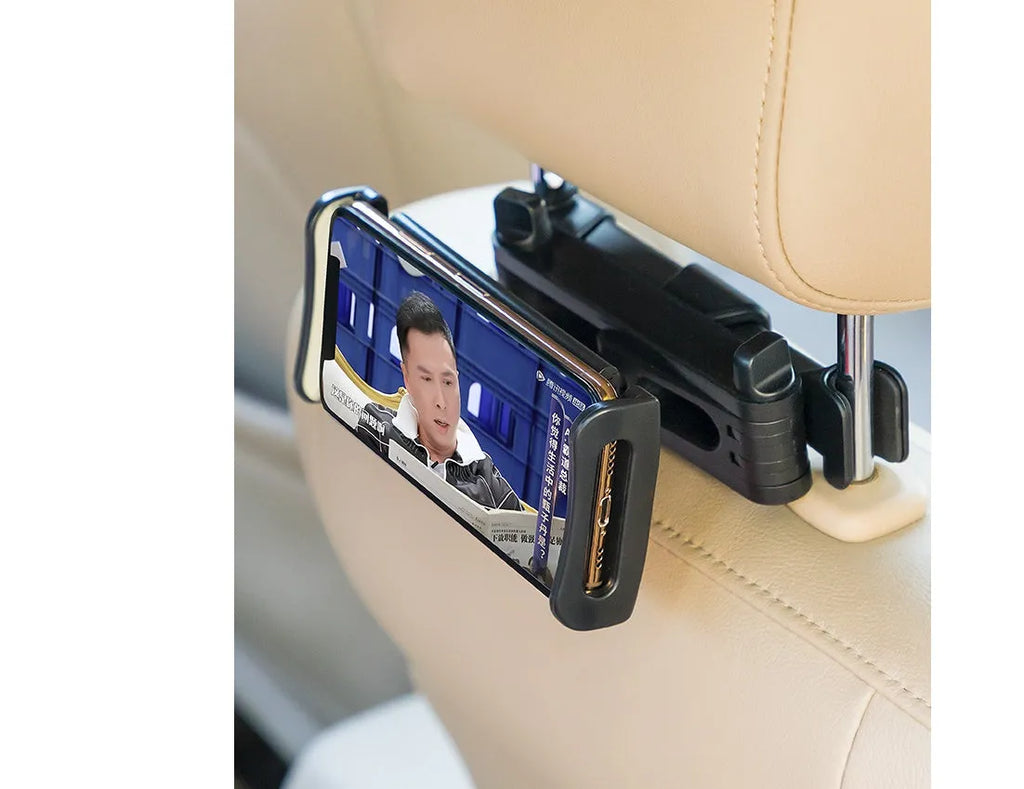 Black car phone holder mounted on vehicle rear seat base with tablet device secured in place