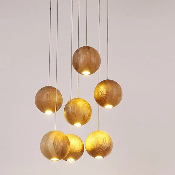 Nordic solid wood ball chandelier pendant light with wooden shade, shown in a living room setting.