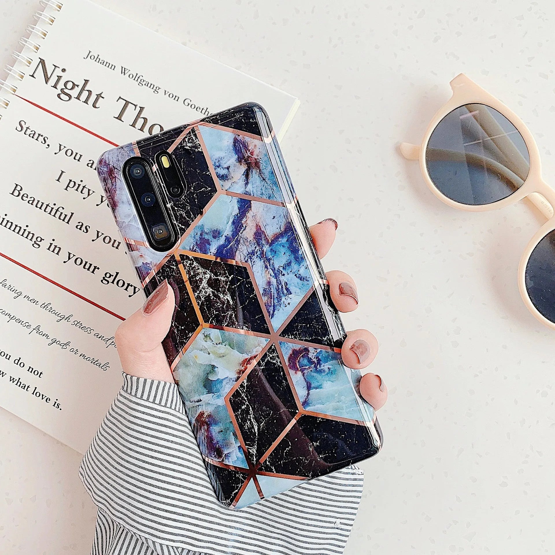 Glossy electroplated marble design TPU back cover case for a Huawei smartphone.