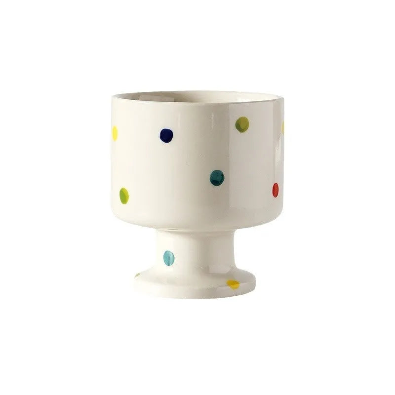 Hand-pinched irregular ceramic mug in a solid colour, showing unique handmade shape.
