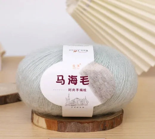 DIY mohair scarf weaving kit showing one wool ball and a selection of 34 colour options including white, pink, blue and green.