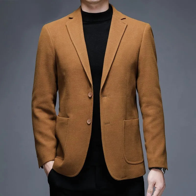 Men's loose fit wool suit jacket in solid colour showing round hem design and long sleeves