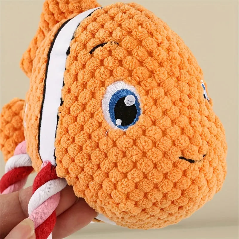 Green turtle-shaped plush dog chew toy with a knotted rope visible inside, on a white background.