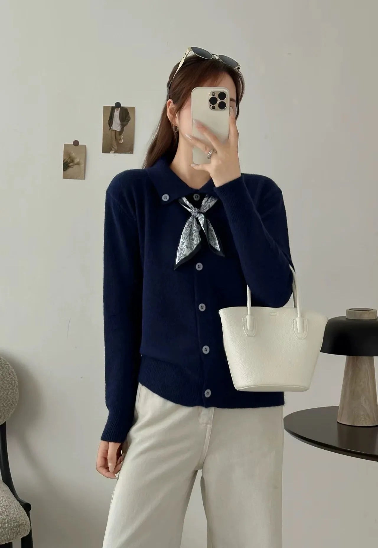 Women's beige lapel scarf collar acrylic cardigan sweater on a hanger.