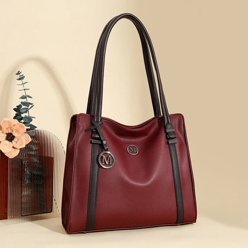 Woman holding a large soft black PU leather retro crossbody bag with double shoulder straps.