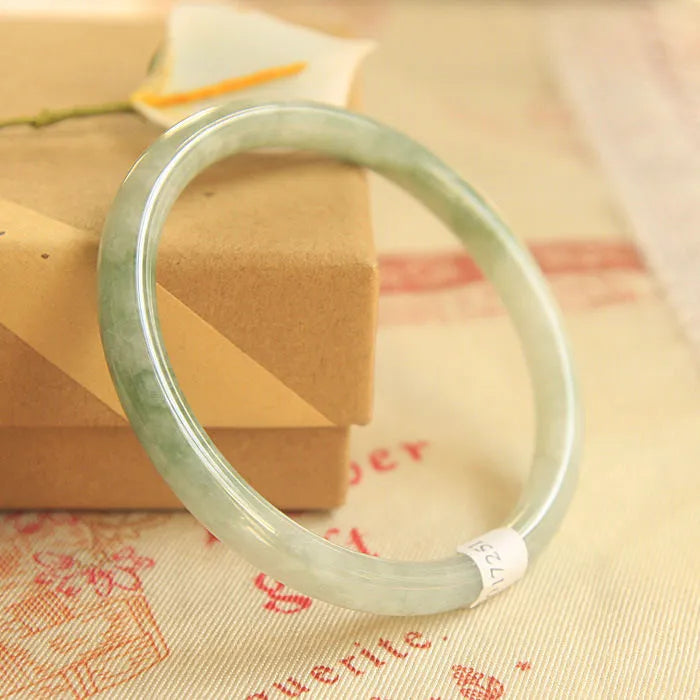 Green jade geometric bracelet with waxy finish showing 10mm width and adjustable sizing