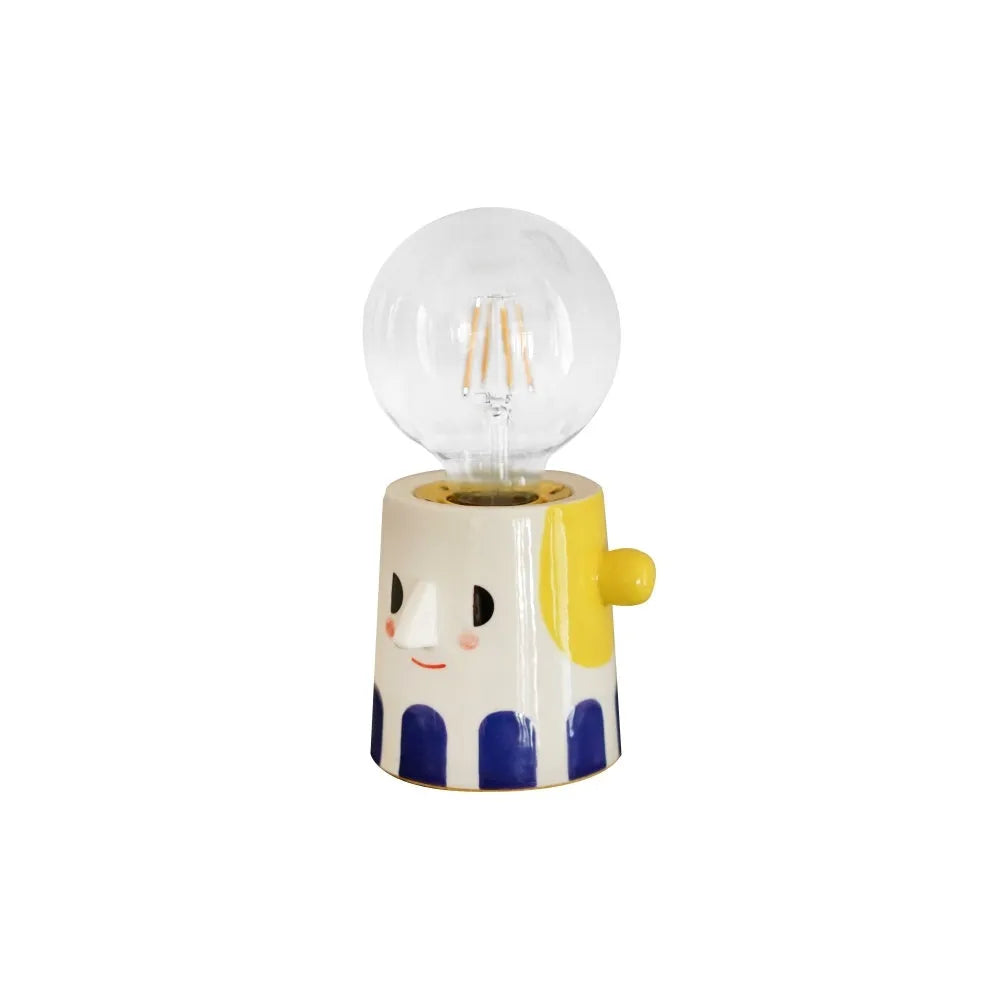 Handmade ceramic table lamp with ball headlight design on bedside table