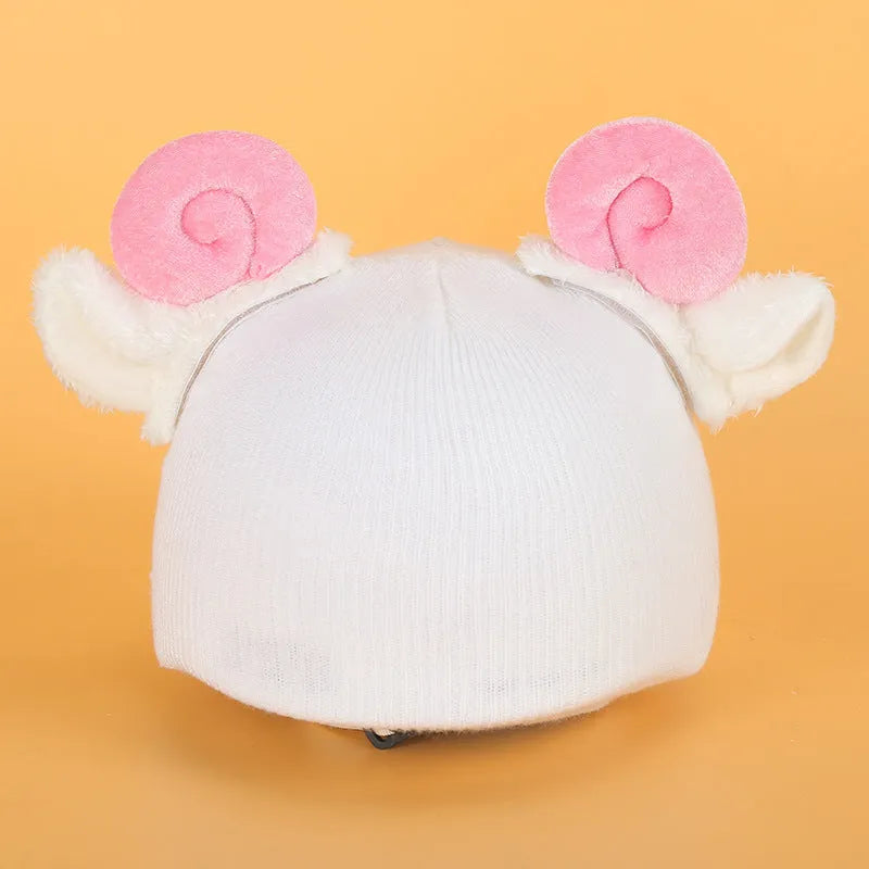 Plush fabric ski helmet decoration with cartoon design on a black ski helmet.