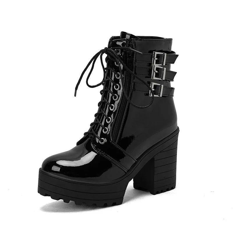 Women's black ankle boots with thick heel, round toe, and front lace-up on a waterproof platform sole.
