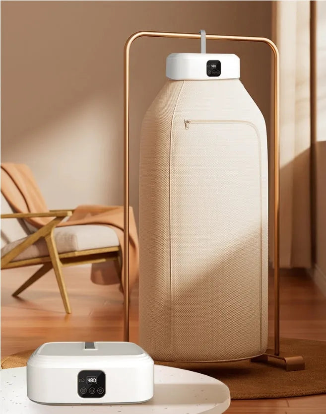 White cylindrical laundry dryer with remote control on surface showing compact 29cm length design