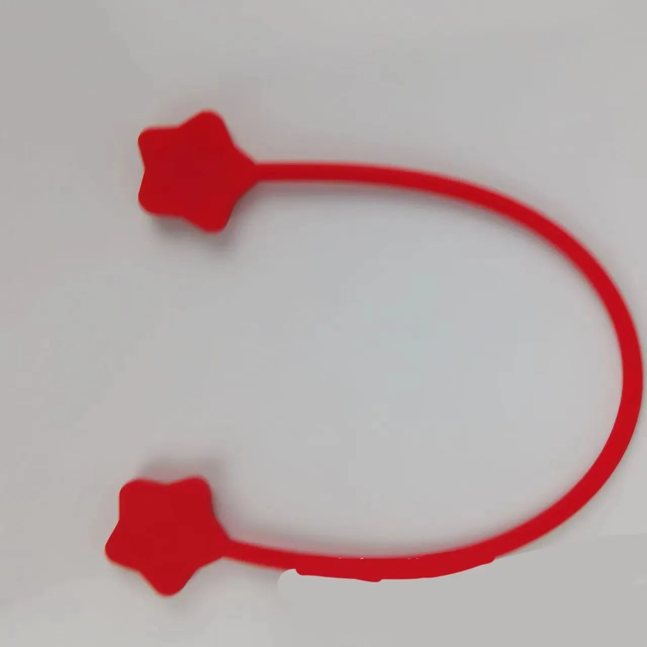 Silicone wire winder with magnet for organising cables in assorted colours on a white background.