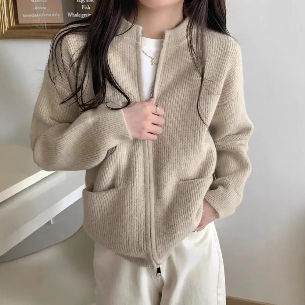 Beige soft viscose knit cardigan with long sleeves shown on a hanger.