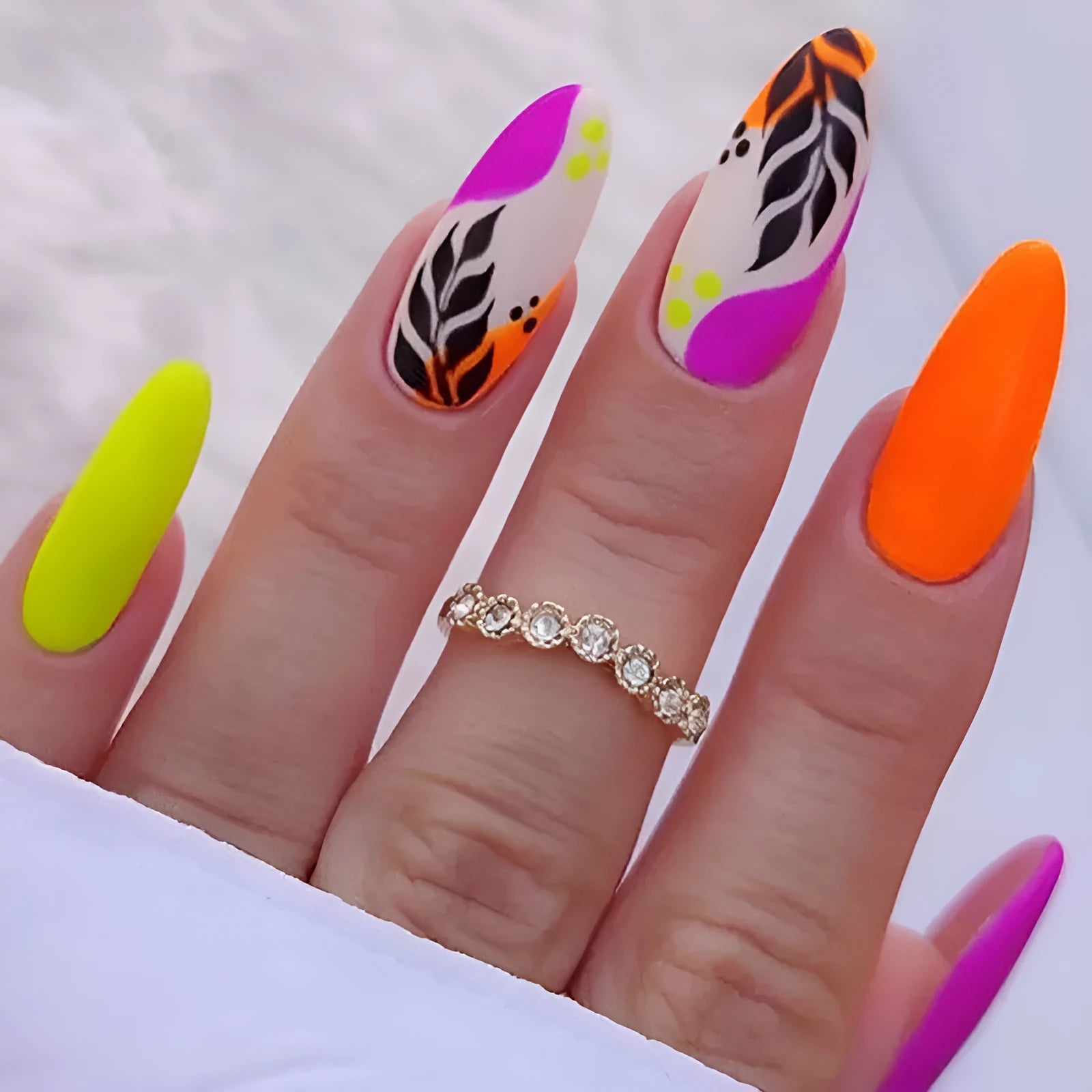 Almond-shaped false nail stickers showing French colourful leaves, gradient leopard print, star flash macaron and colourful plating designs