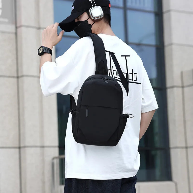 Men's grey lightweight chest bag with large main compartment and shoulder strap.