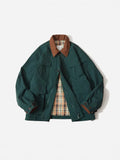 Green unisex casual jacket with contrast colour panels and side seam pockets on a model.