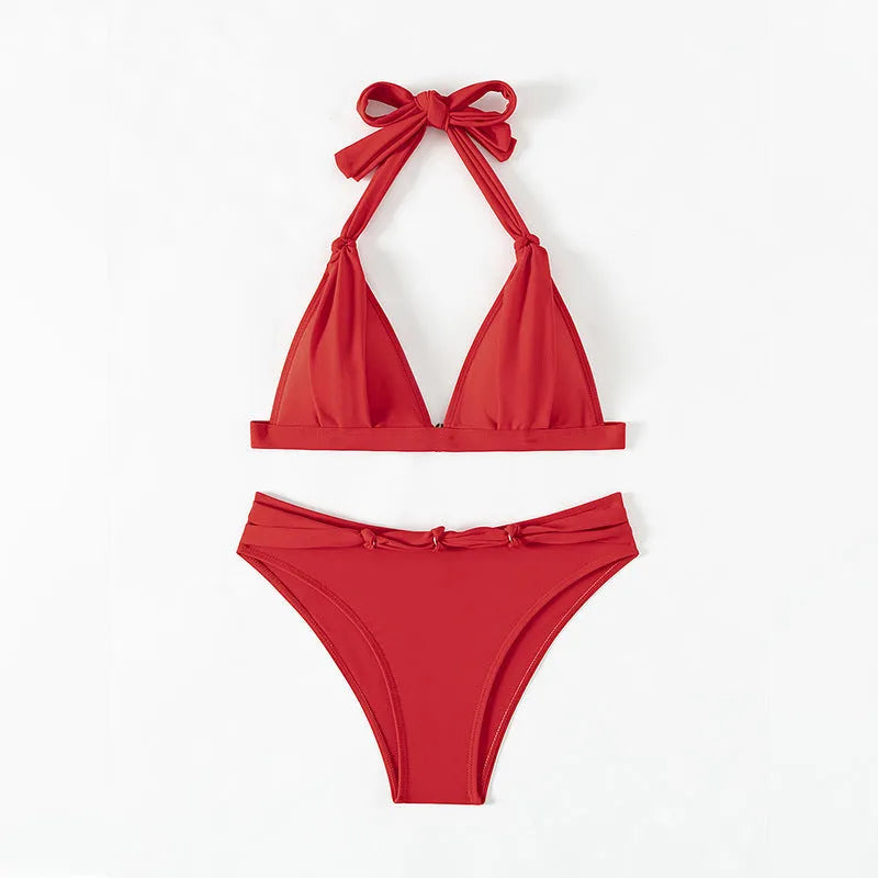 Red women's lace-up halterneck bikini set with split-leg shorts for beach swimming