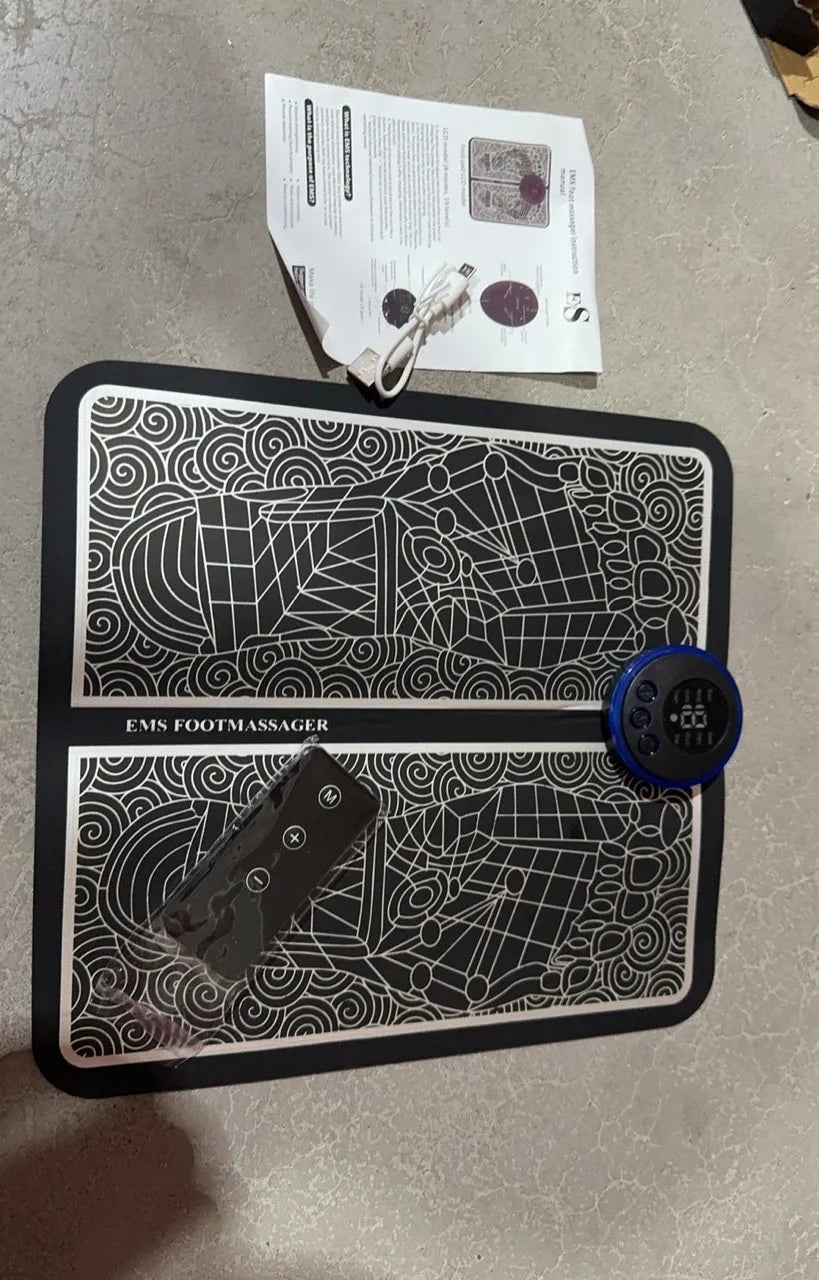 English Style leather foot massage cushion with wireless remote control and LCD display showing massage modes.