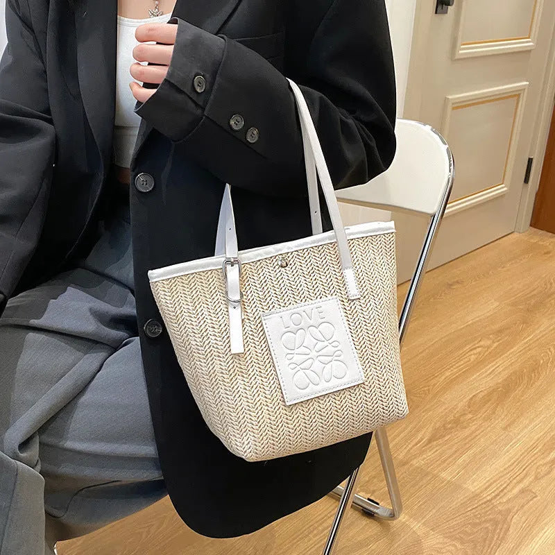 Straw woven women's shoulder bag with three-dimensional pockets in black colour option
