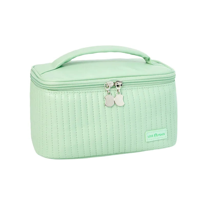Open-top pink PU leather cake-style makeup bag on a table