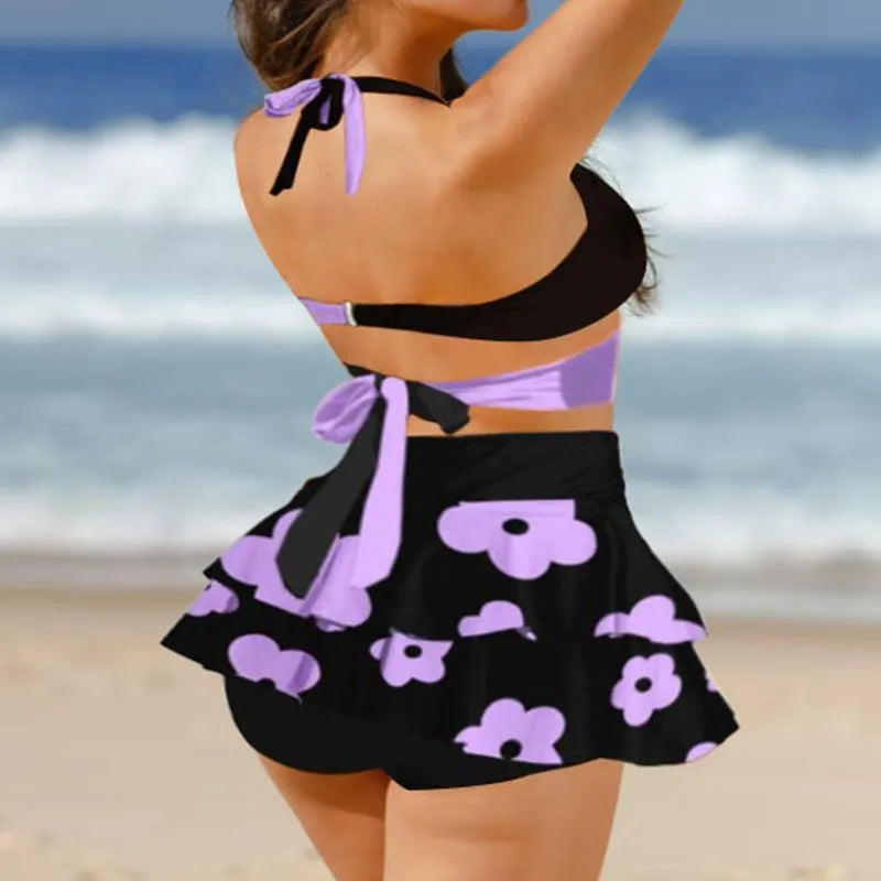 Women's black high-waisted bikini swimsuit with lace-up detail and matching skirt.