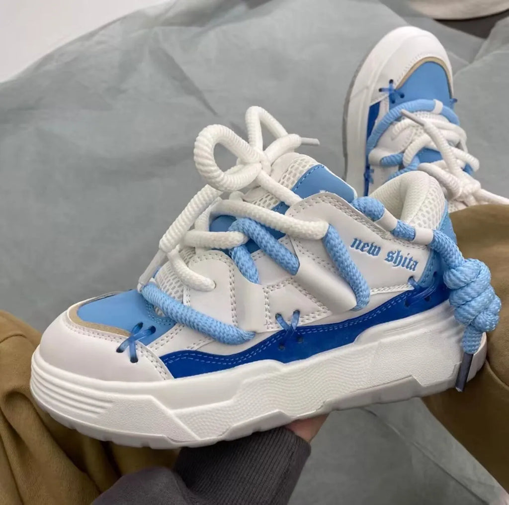Women's grey retro platform sneakers with thick rubber sole and front lace-up closure