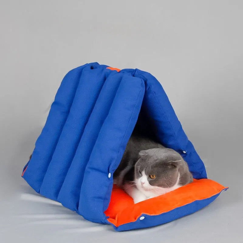 Blue triangular cat bed with drilled holes on the sides for combination, showing removable cotton cover.