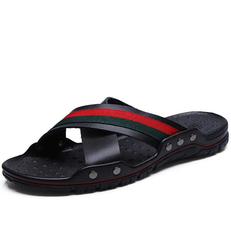 Men's cowhide leather flip-flop sandals with a non-slip PU sole in black, shown on a sandy beach.