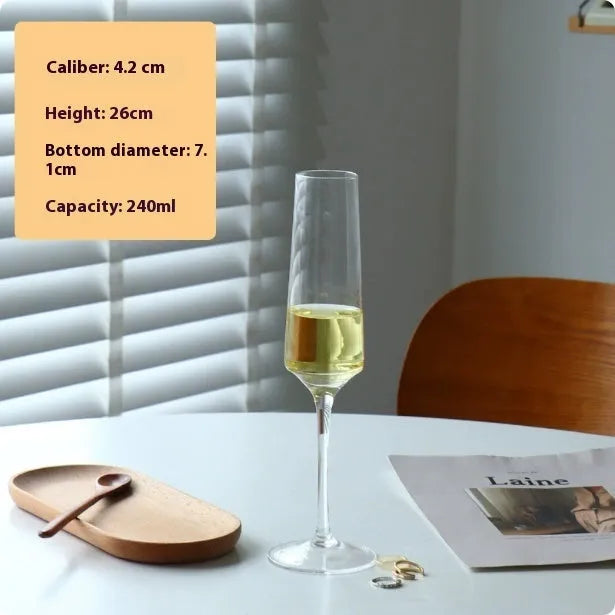 A single clear French goblet champagne glass on a table.