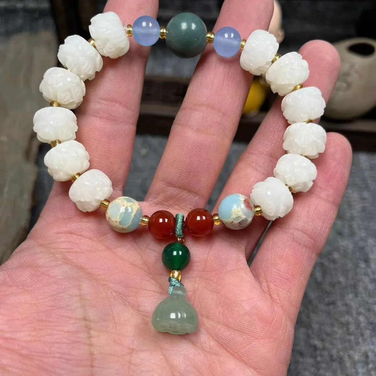 Carved pumpkin lotus bodhi root bracelet with white jade segments and golden silk jade treasures