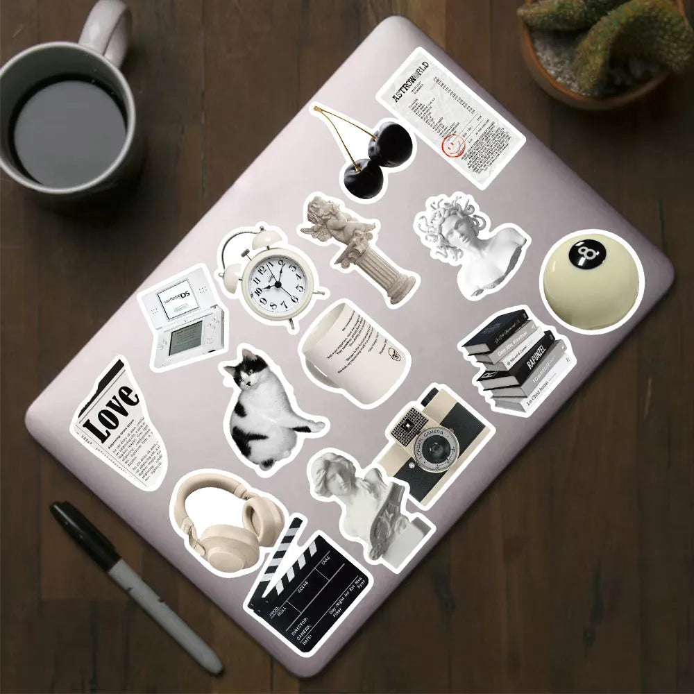 61-piece black and white waterproof PVC sticker set for laptops, phones, and luggage.