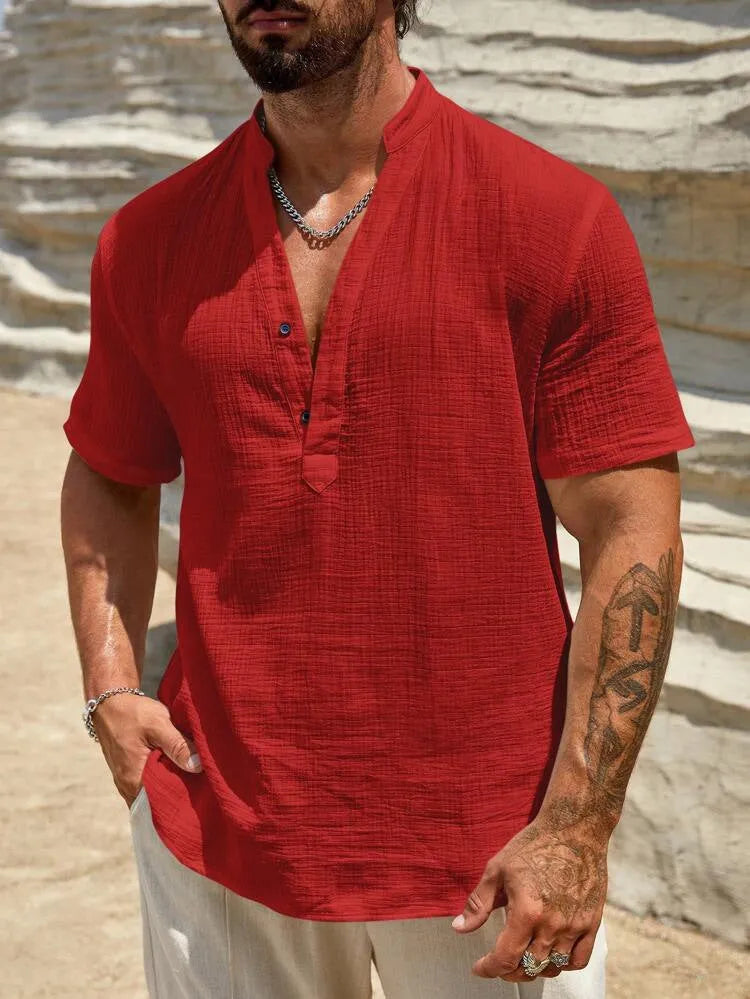 Men's solid colour stand collar short-sleeved casual shirt laid flat, showing slit detail and thin fabric.