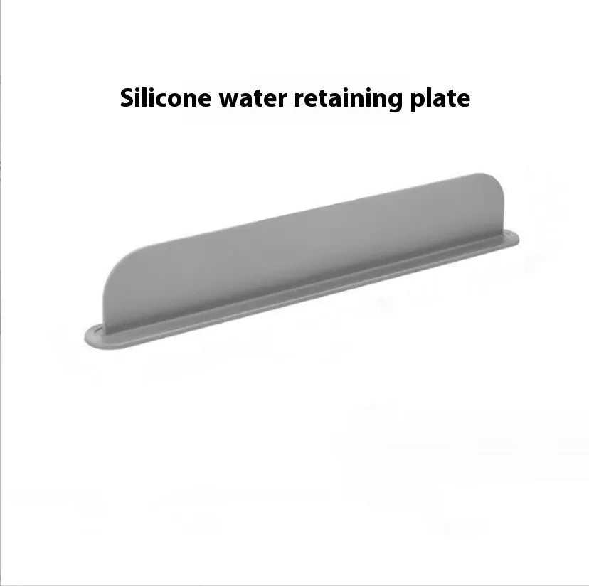 Thick grey silicone kitchen sink water blocking plate sitting on a counter next to a sink