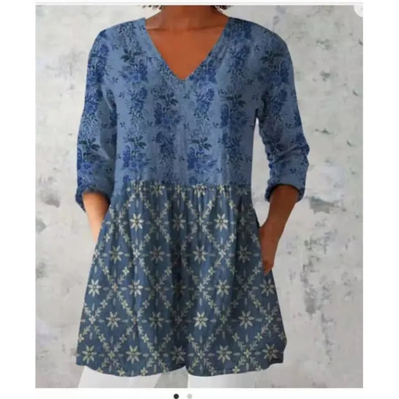 Women's printed wave pattern loose dress with wide waist and three-quarter length sleeves on a hanger.
