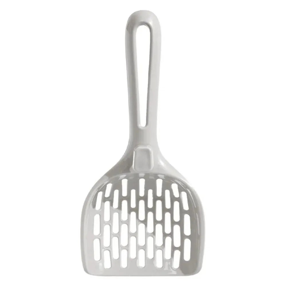 Grey plastic cat litter scoop with handle sitting upright in its integrated square base.