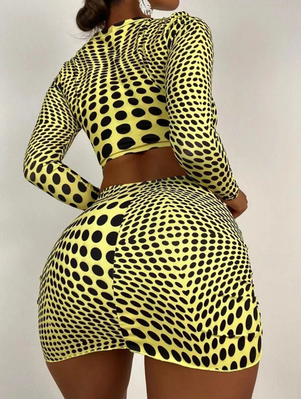 Green and yellow polka dot women's swimsuit three-piece set with top, skirt, and bra.